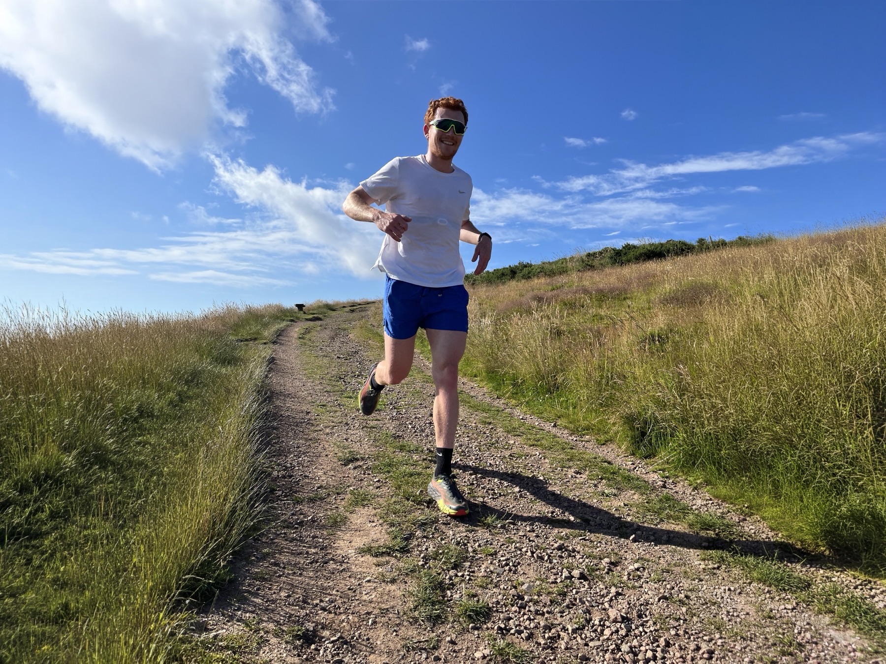 George running on a hill trail